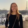 Valentine Julien on a balcony above Place de la Concorde, the Eiffel Tower behind her