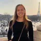 Valentine Julien on a balcony above Place de la Concorde, the Eiffel Tower behind her