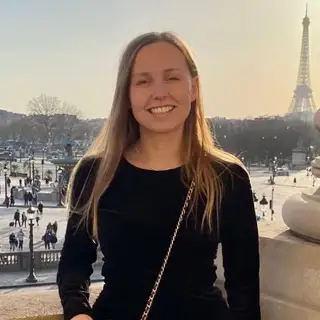 Valentine Julien on a balcony above Place de la Concorde, the Eiffel Tower behind her